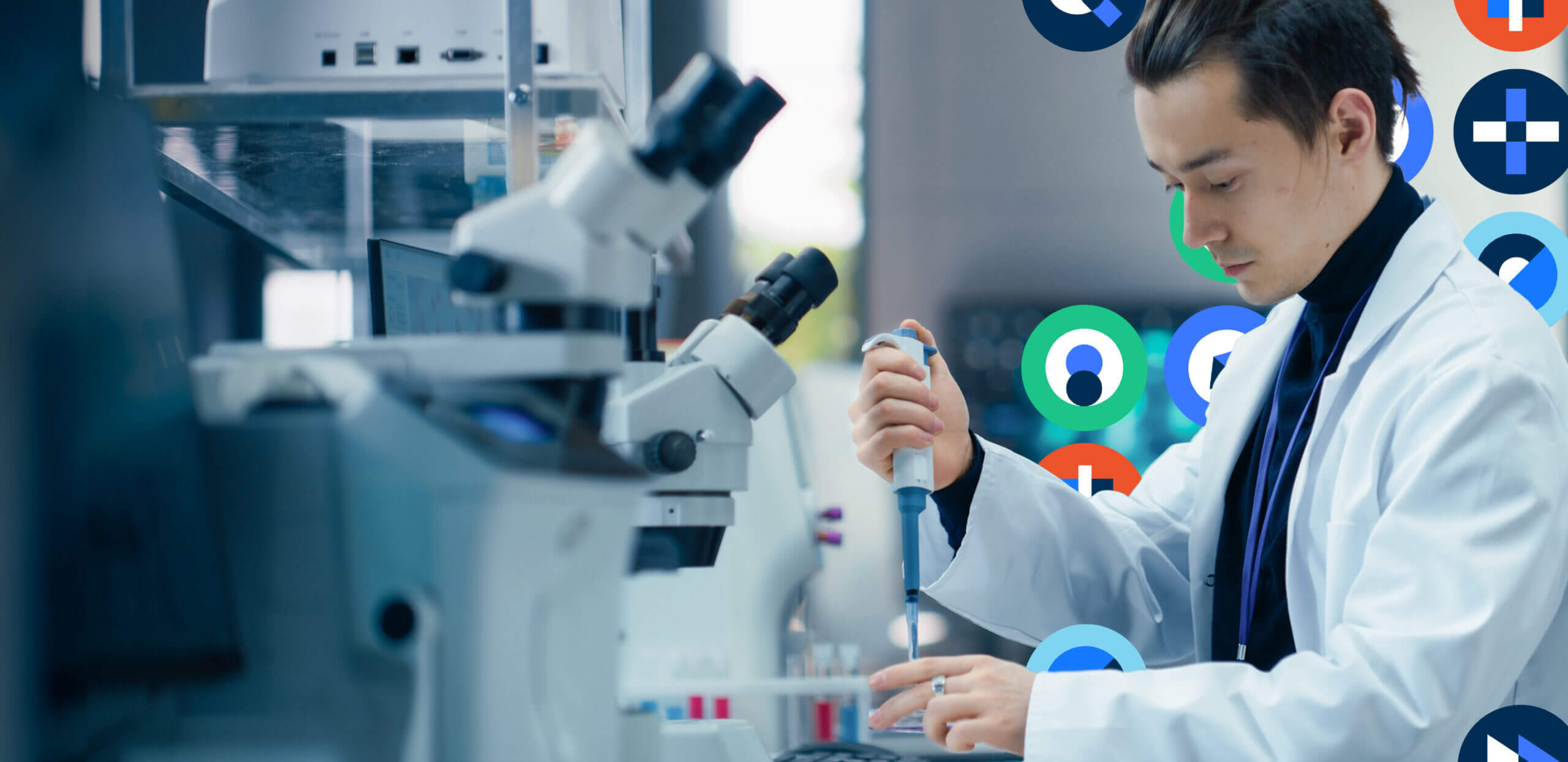 A scientist holds a micropipette, transferring liquid into tubes beside a microscope, working at a well-lit laboratory bench with test tubes and colorful circular graphics in the background.