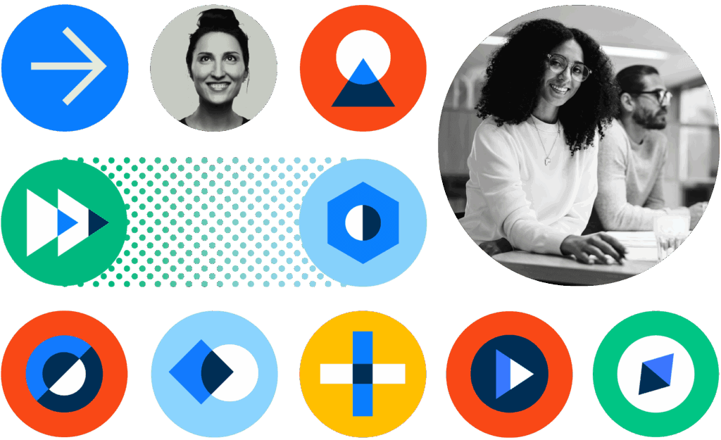 A grid of colorful circular icons surrounds a large circular black-and-white photo of two coworkers; icons show abstract geometric symbols and arrows while the coworkers work at a desk.