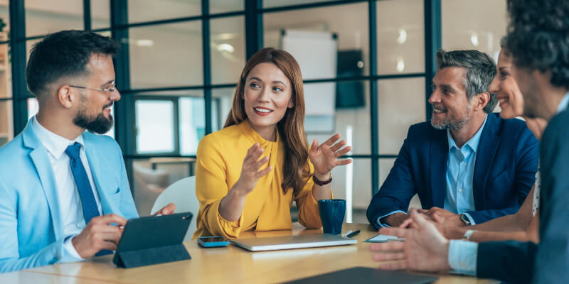 Group of business persons in business meeting. Group of entrepreneurs on meeting in board room. Corporate business team on meeting in the office having discussion. Senior managers sharing ideas for new strategy