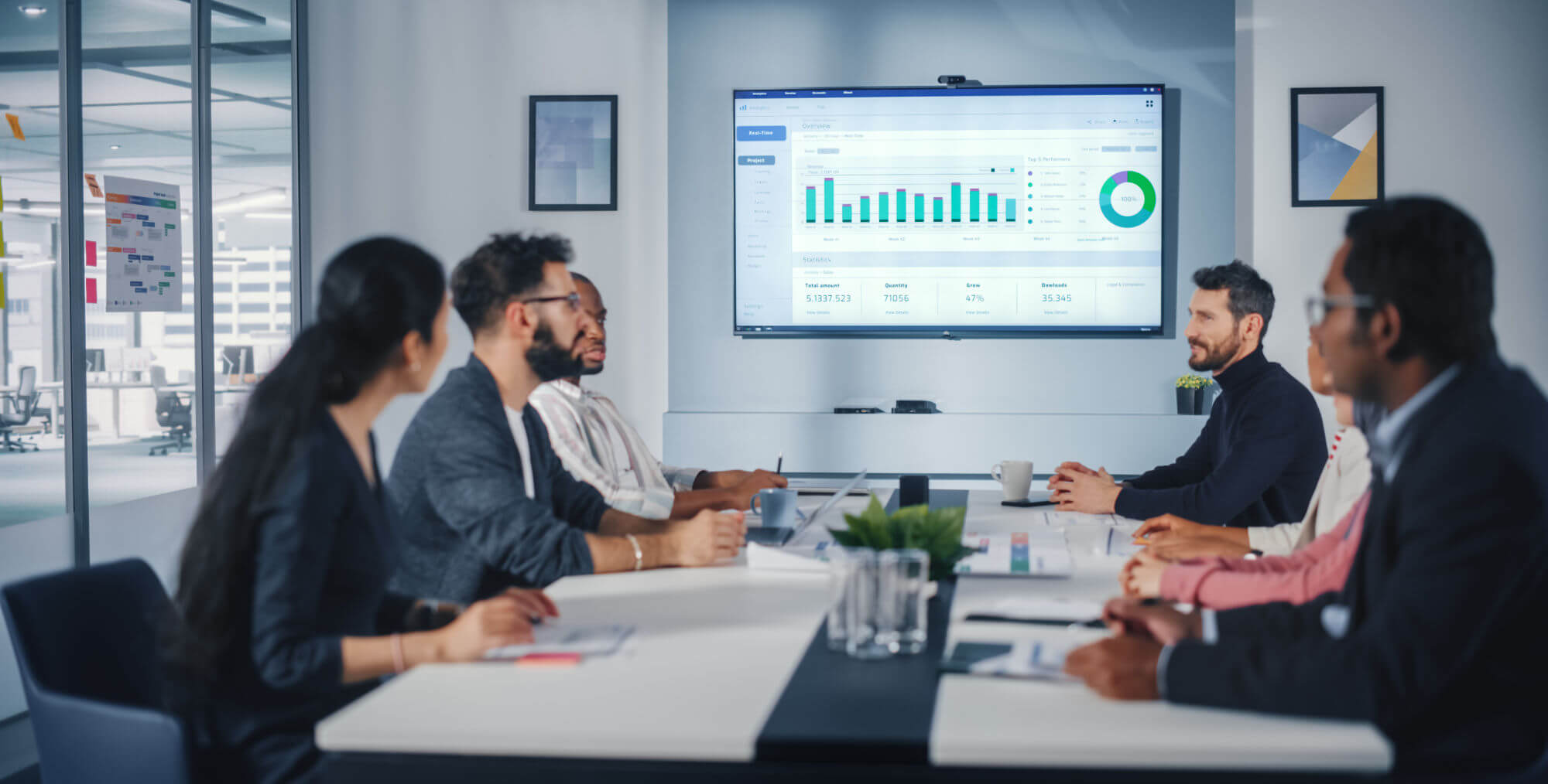 Diverse team of businesspeople discussing data and charts.