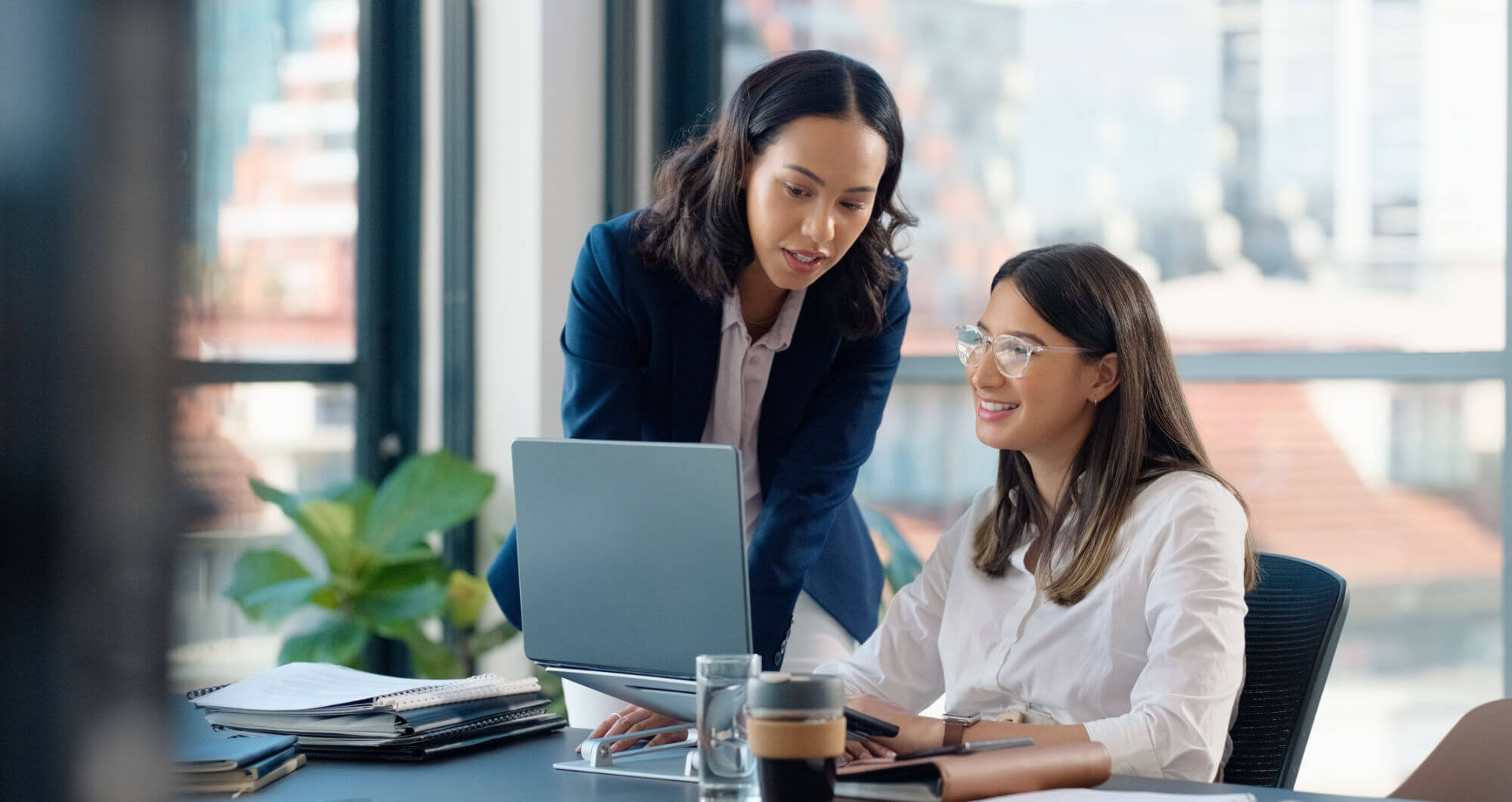 Business people, laptop or learning in training in discussion or conversation for news, education or advice. Teamwork, woman coaching or leader talking for online data or new job in digital agency