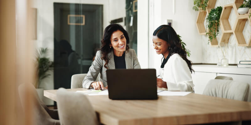 Meeting, women and business people with laptop in office, investment project and discussion. Teamwork, accountant and financial advisor with feedback for finance update, report review and documents