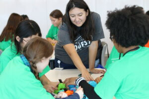 A Roche volunteer walks a group of students through an activity at the October 2024 Career Quest event.