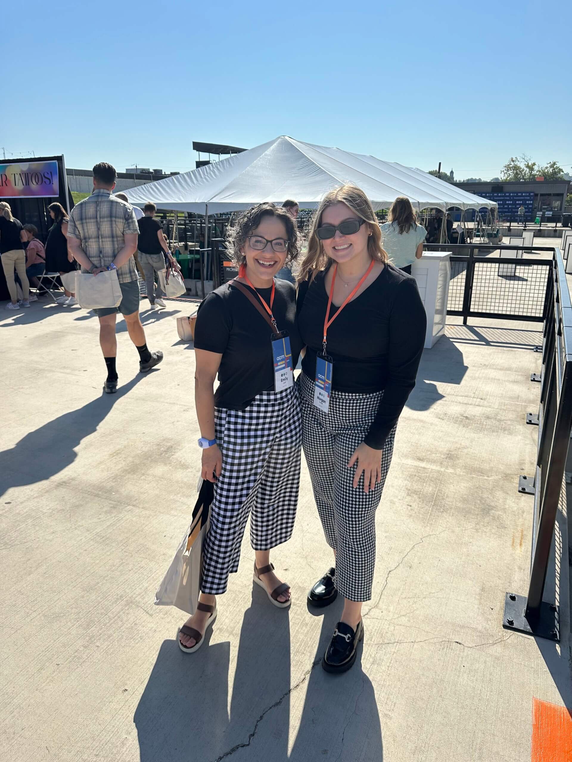 Two ladies wearing very similar black shirts and plaid pants. #twinning