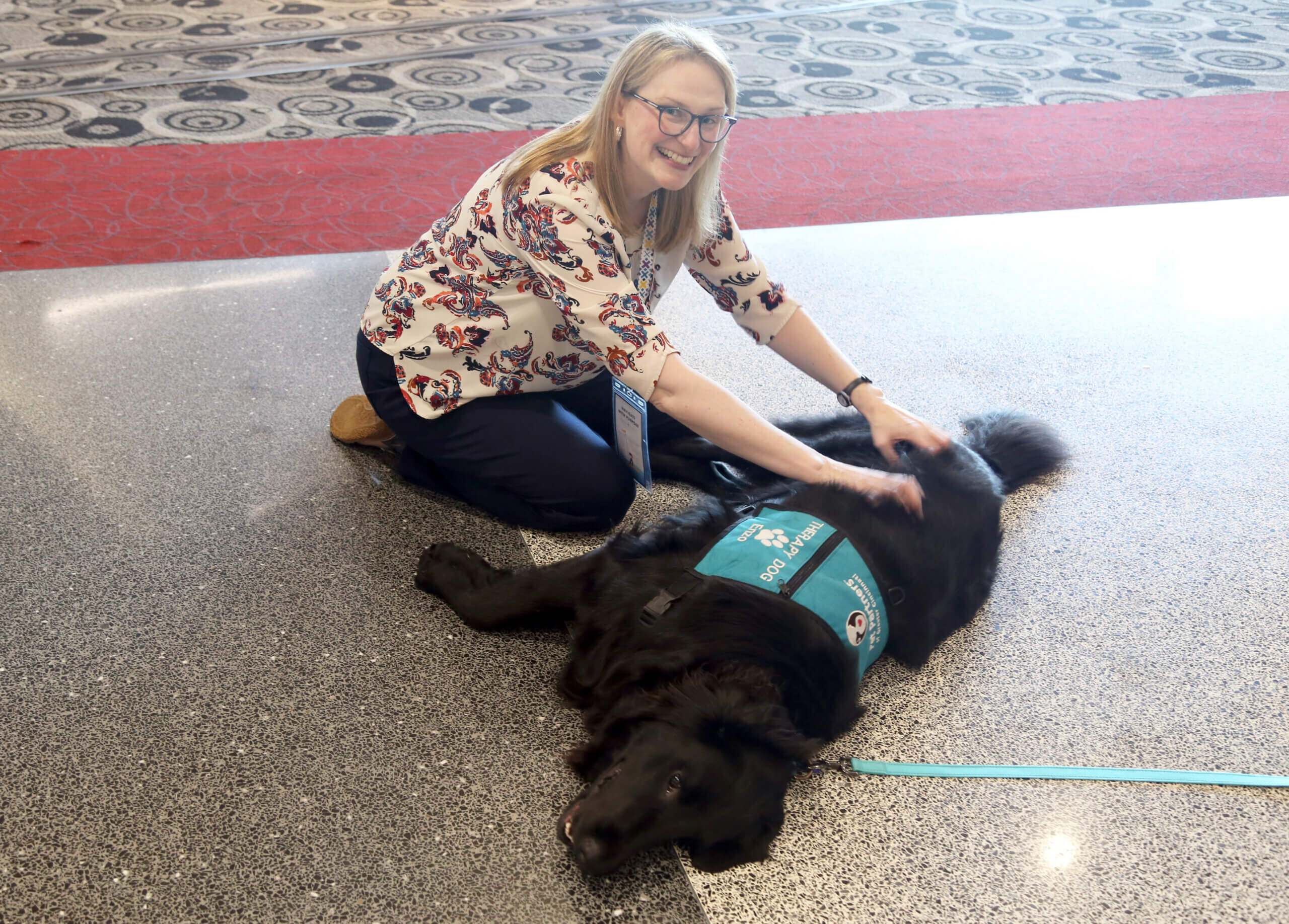 Woman petting a therapy dog