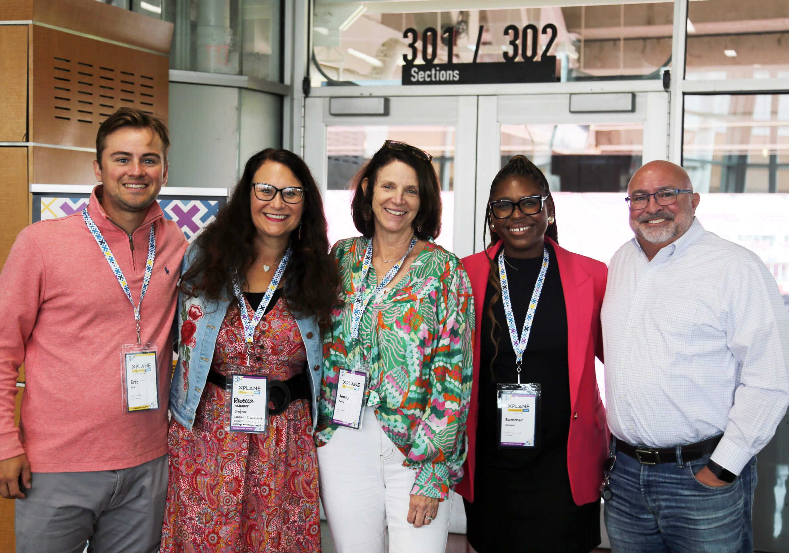 A group of conference attendees posing for a picture.