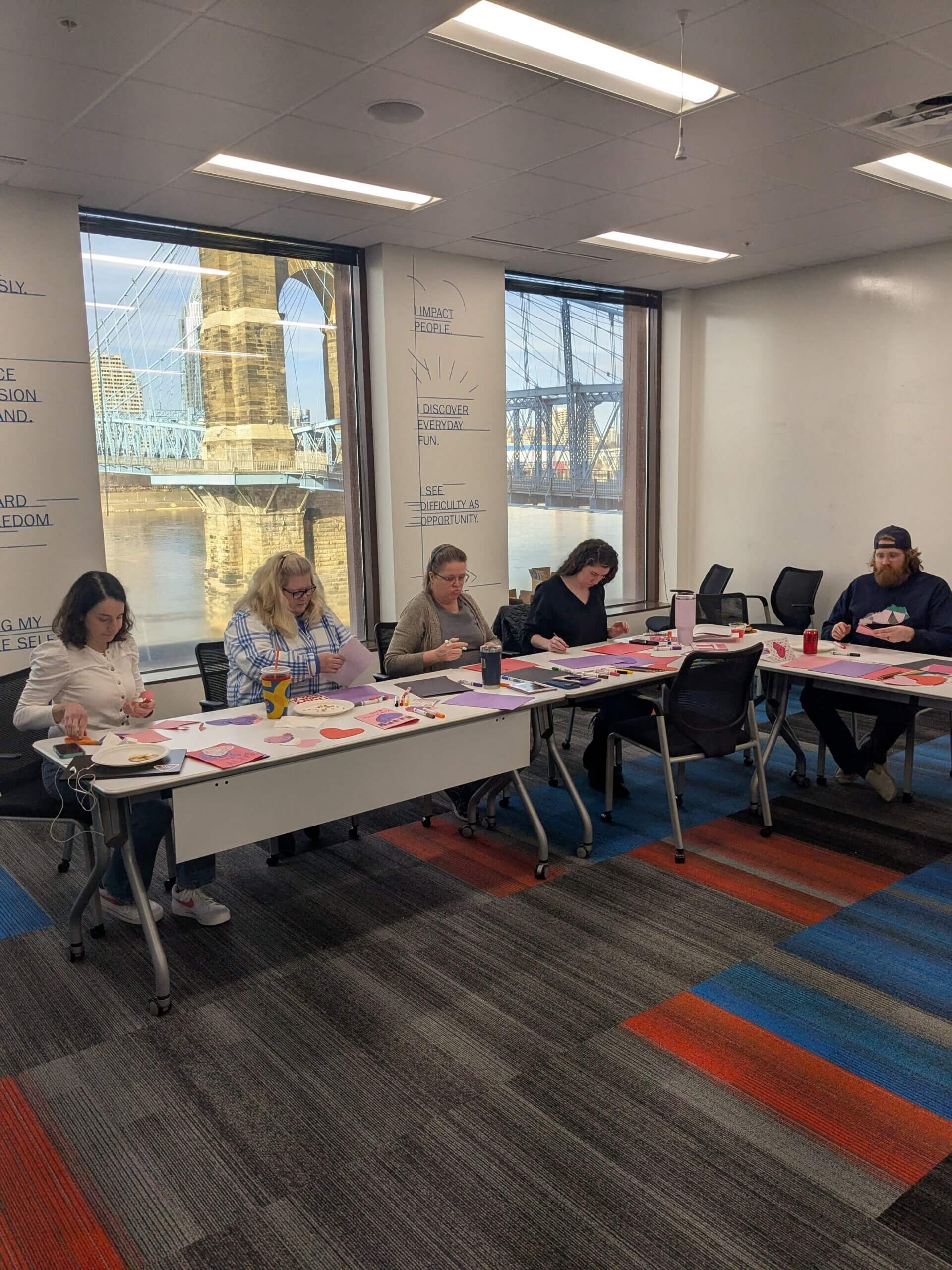 A group of people making cards for a Valentine's activity.